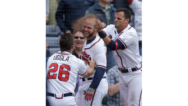 McCann homers twice, Braves beat Astros 3-1 in 11