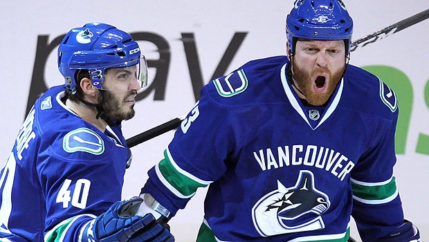 Canucks bust out offense, rout Sharks in Game 2