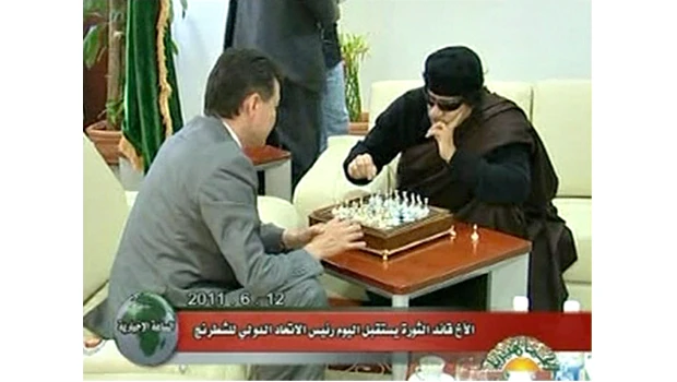 As Libya burns, Qaddafi plays chess