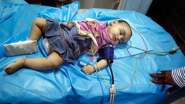 Qaddafi aides present car crash baby as NATO victim