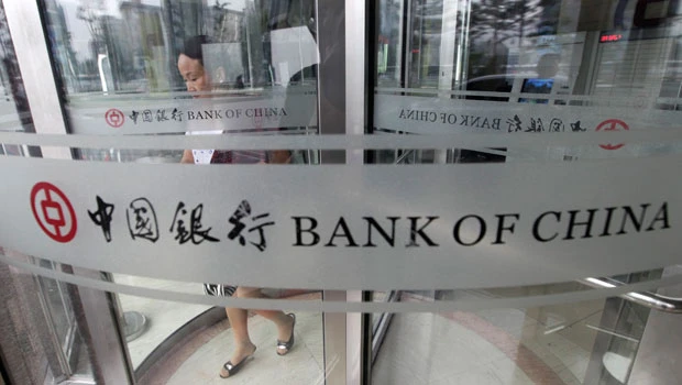 China raises rates, shrugs off slowing growth