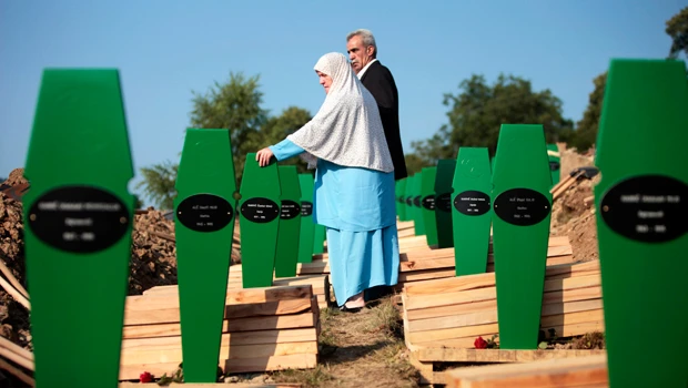 Srebrenica survivors bury dead, want quick Mladic conviction