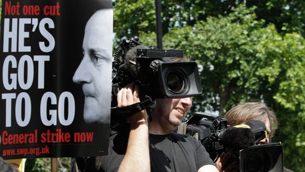 Britain’s Cameron faces grilling on hacking crisis