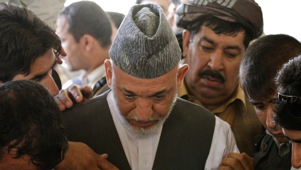 After burying slain influential brother, Afghan president crowns heir