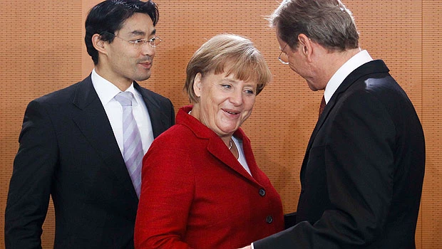 Merkel backs euro fund boost, faces revolt risk