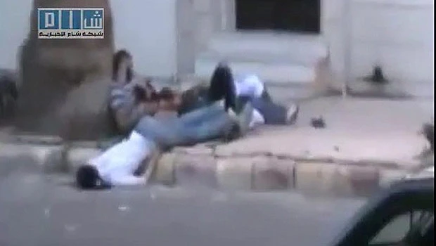 Syrian troops fire as thousands protest Assad