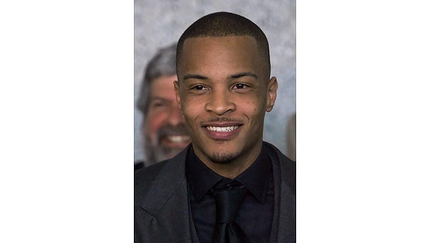 Rapper T.I. back in federal prison after luxury bus ride