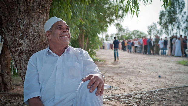 Qaddafi unburied, Libyans maneuver for new era