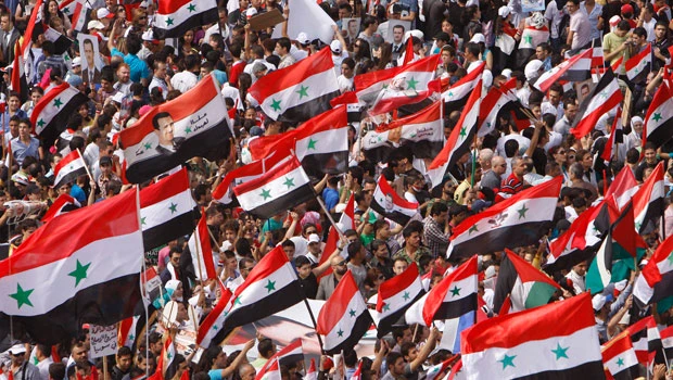 Tens of thousands in Syria stage pro-Assad rally