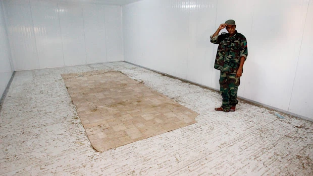Qaddafi body handed to NTC loyalists for burial