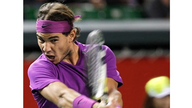Nadal charges through in purple haze