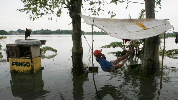 Filipinos still trapped on roofs; typhoons kill 59