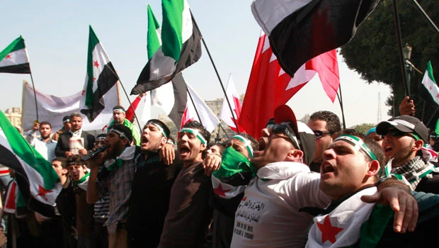 Shrouds laid in Cairo street as Arabs meet on Syria