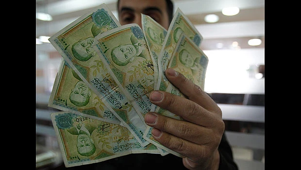 Syria's currency sags under weight of unrest