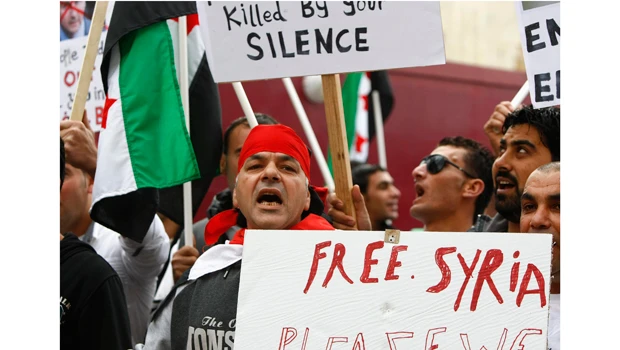 Syria nearer to sign Arab plan, crackdown continues