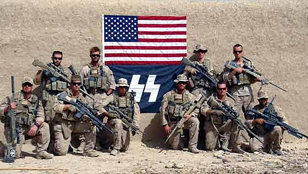 Marines posed with logo resembling Nazi symbol