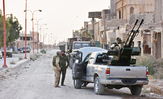 Syrian government forces stand in Kobajjep some 40 kilometres west of Deir Ezzor. (AFP)