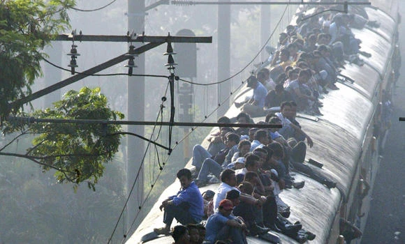 Indonesia lowers power lines to deter train surfers