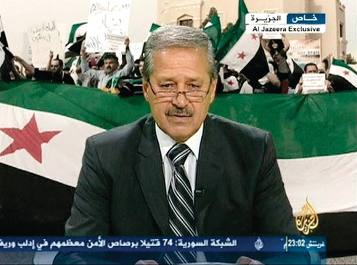 Top Syrian envoy defects, urges revolt; troops raid Damascus suburb