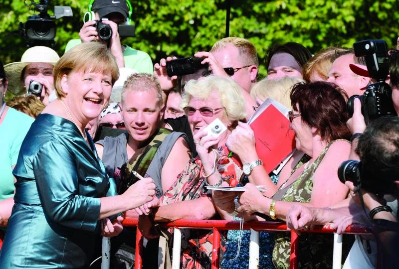 Penny-pinching Merkel recycles dress