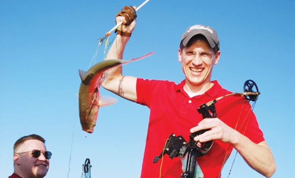 US carp hunters spike flying fish with bows and arrows