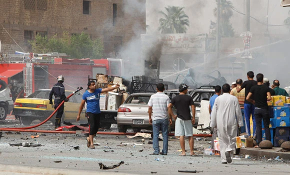 Officials: 14 killed in twin Iraq car bombs