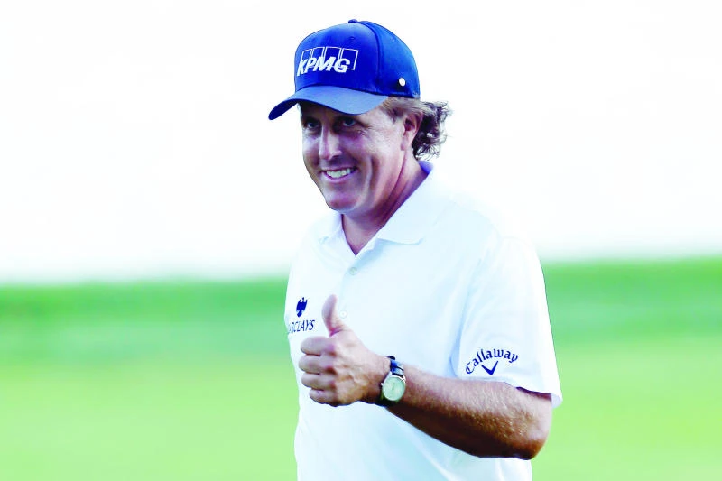 Mickelson charges into share of BMW lead