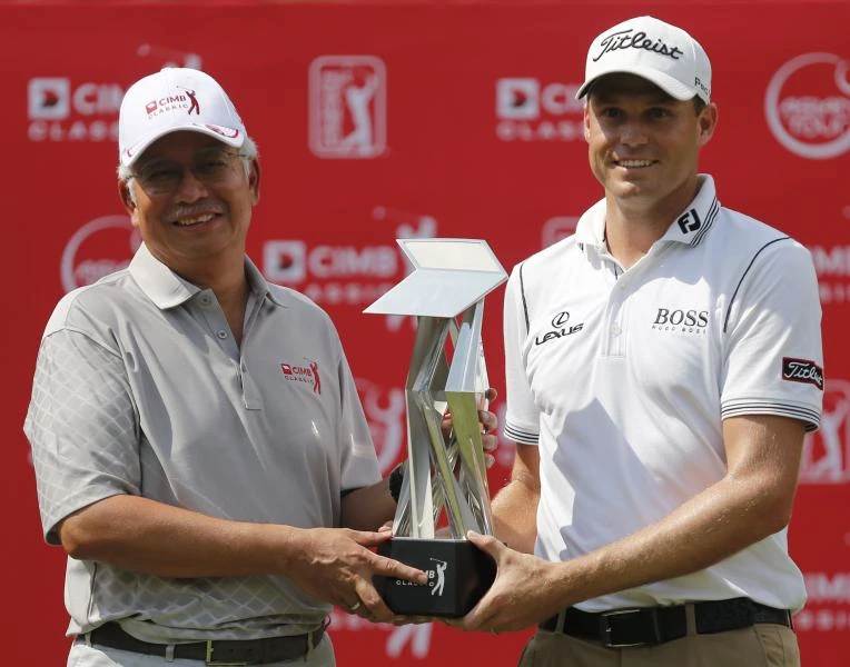 Watney shoots 61 to win in Malaysia; Woods fourth.