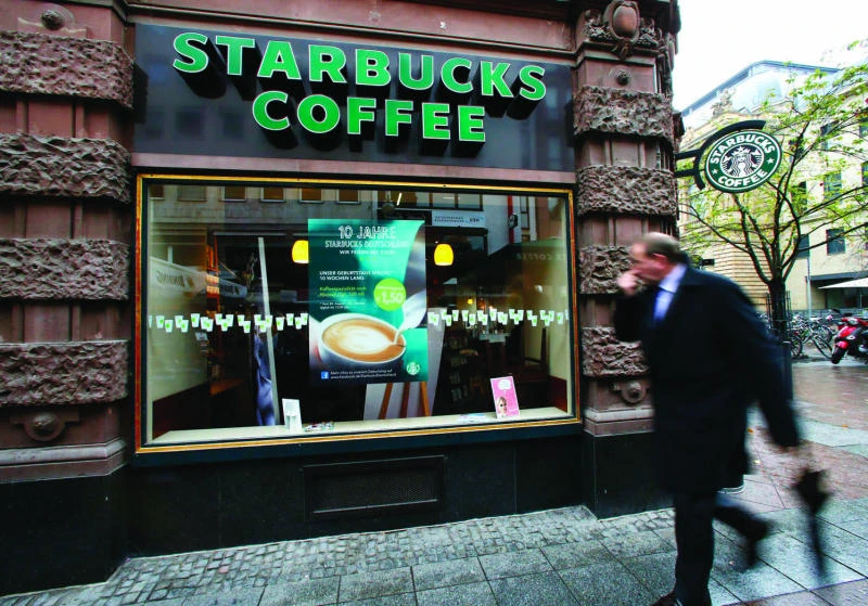 Starbucks raises forecast, defies industry trend