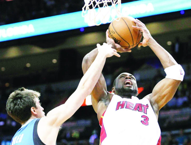 Wade, James to fore as Heat survive T'Wolves