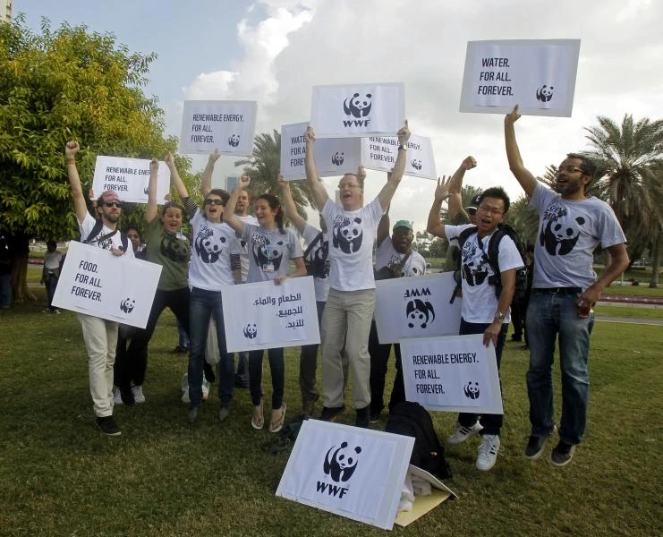Climate activists march outside UN talks in Qatar