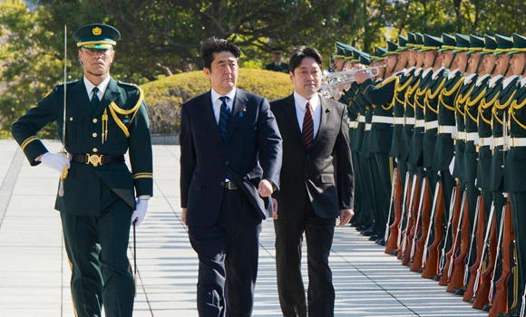 Japan PM points to beefed-up military in speech
