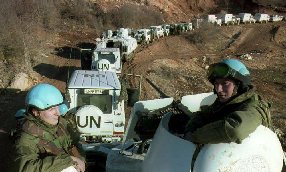 Dutch soldiers accompany a UN convoy of armored vehicles on their way to Lukavac and Srebrenica on February 28, 1994. (AFP file photo)