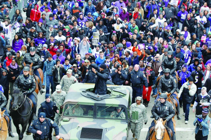 Fans march with Ravens in parade to packed stadium
