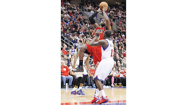 James triple-double lifts Heat over Sixers