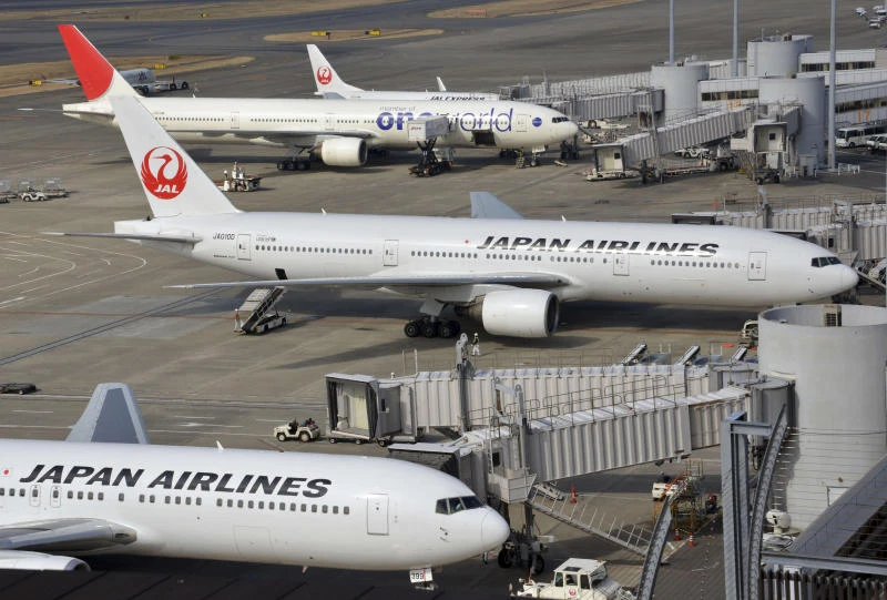 JAL profit slips, ups year forecast