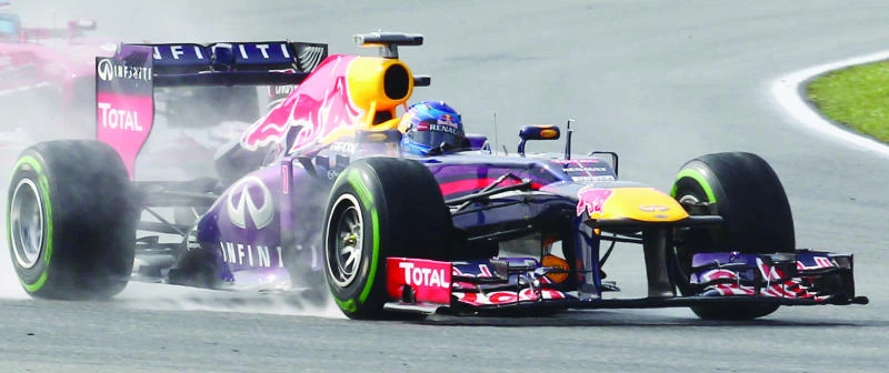 Vettel claims pole at rain-hit Sepang