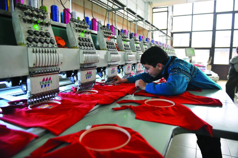 Sewing machines drown out gunfire in Aleppo factory