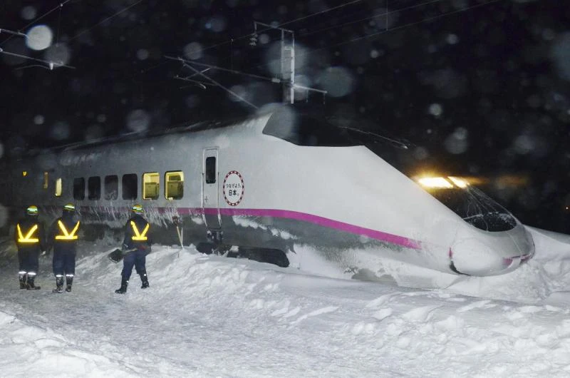 Japan bullet train derails amid snowfall
