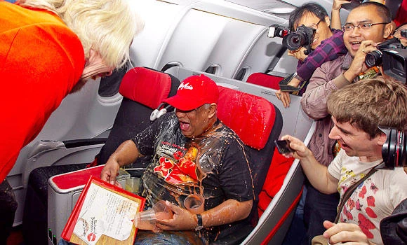 Branson serves as stewardess after losing bet