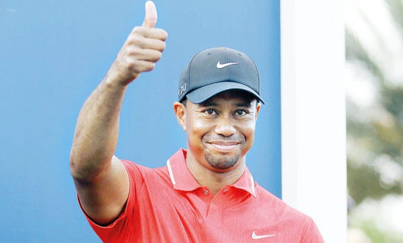 Woods wins The Players in tense finish
