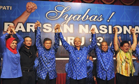 Malaysia’s long-ruling coalition hangs on to power
