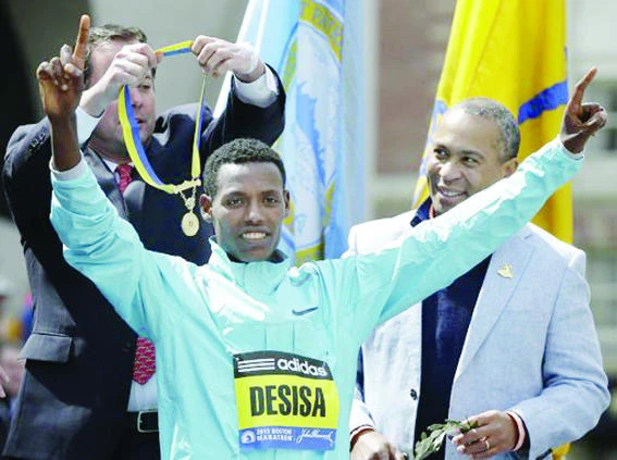 Boston Marathon winner returns his medal to city