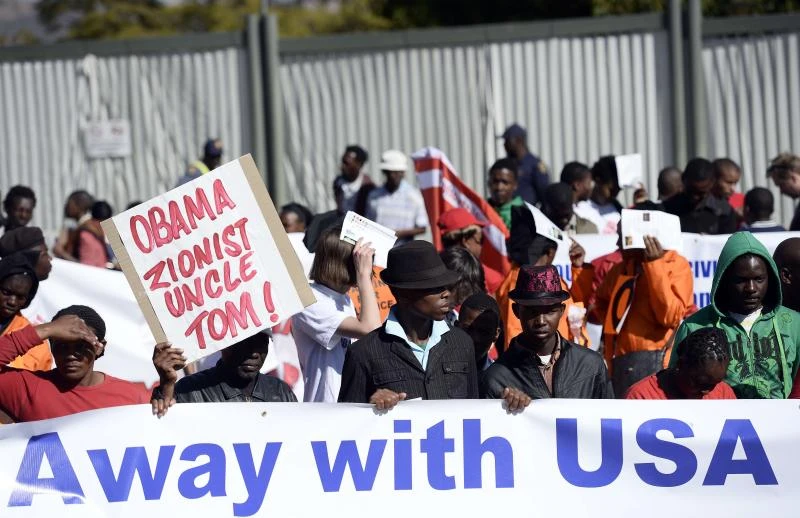 Mandela improving as Obama flies in