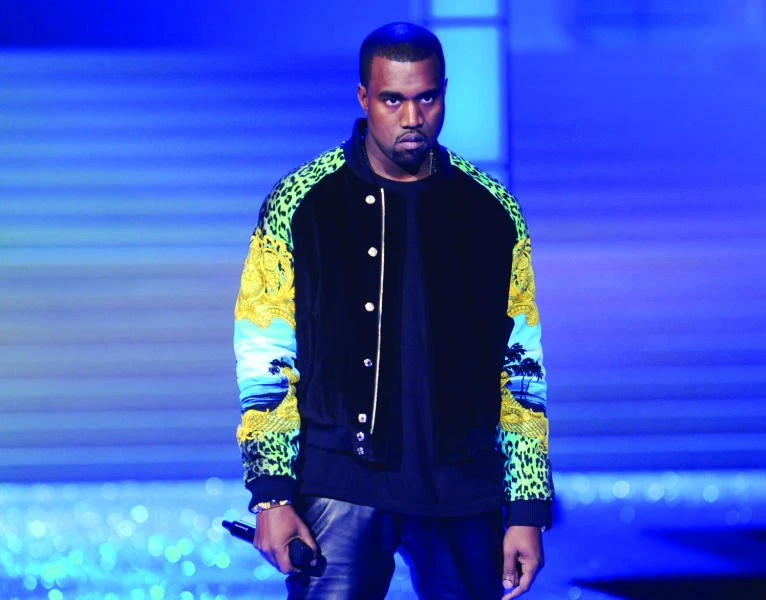 Kanye West scuffles with paparazzi at LA airport