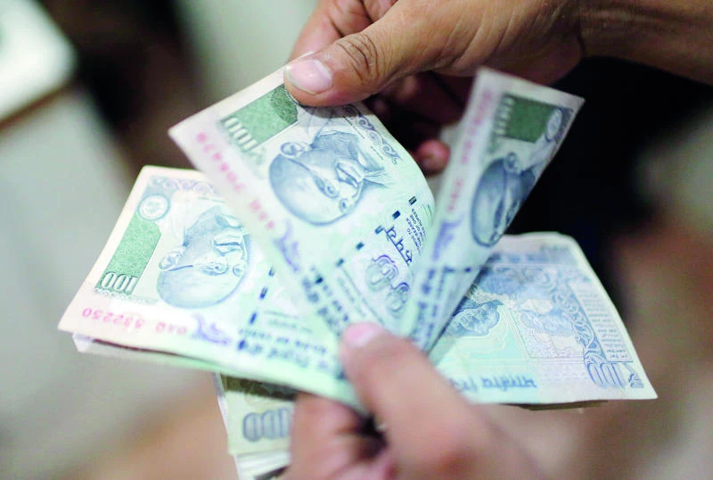 Indian rupee slides to record low