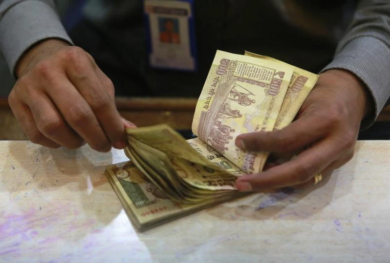 Indian rupee gains tracking peers; dollar demand stays strong