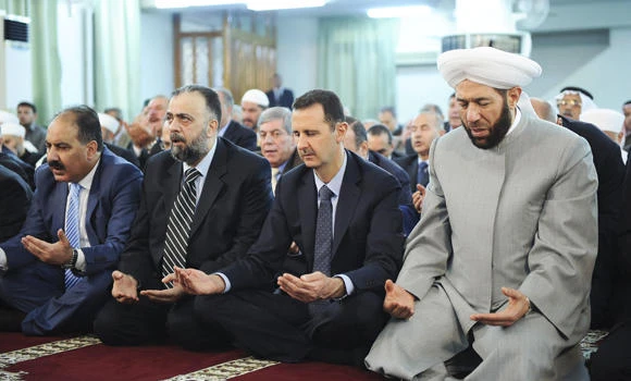 Shells hit Damascus area as Assad attends prayers