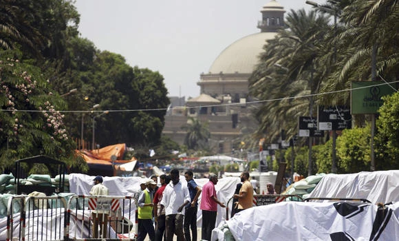 Egypt postpones dispersing protest camps, extends Mursi's detention