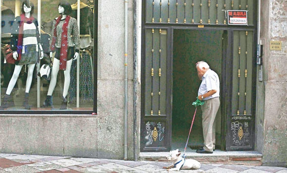 Spain’s indebted cities target beggars, dog owners for cash